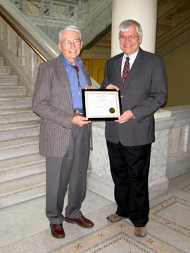 Robert H.  Dott receives the certificate of historical listing.